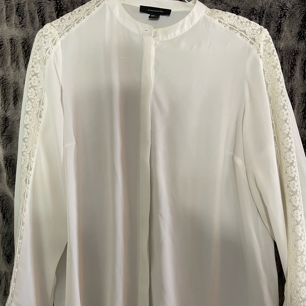 Ivory blouse with lace detail.